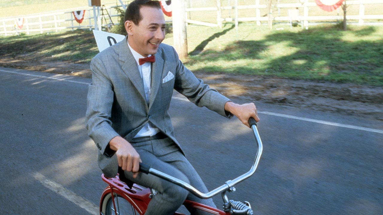 Paul Reubens as Pee-wee herman on a bike in the Pee-wee movie